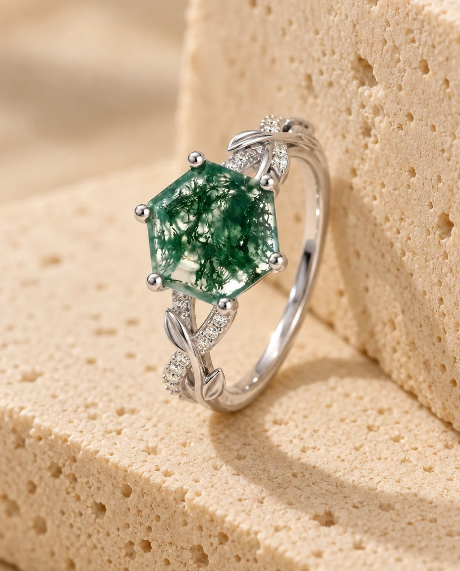 Moss Agate Ring - displayed on a travertine block