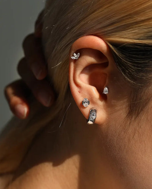Marquise Moissanite Lotus Stud Earrings in 925 Sterling Silver - worn on a model with her hand at the back of her head