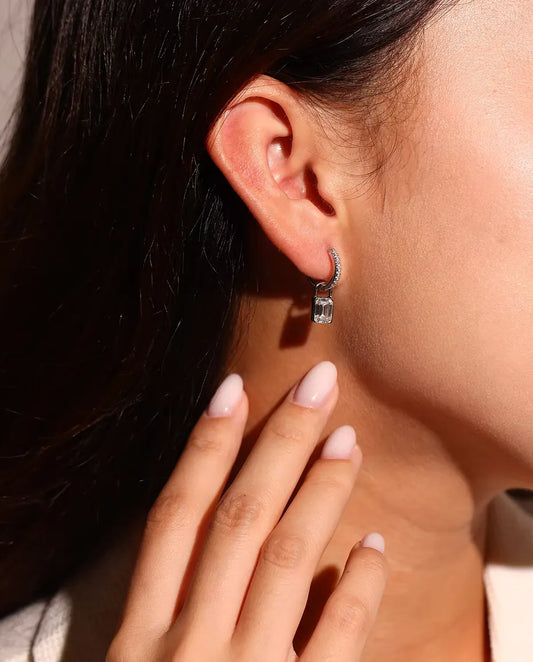 Moissanite Padlock Hoop Earrings in 925 Sterling Silver - worn on a model’s ear, close-up