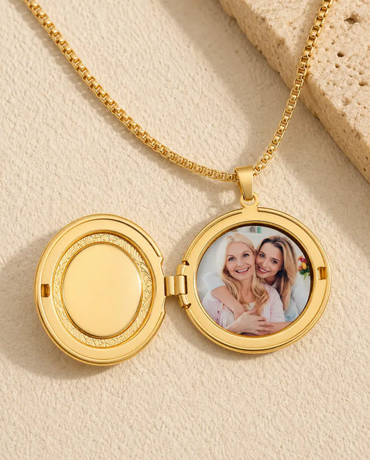 Round locket opened to show one photo inside the polished gold frame