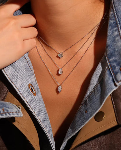 1 ct Marquise Moissanite Necklace in 925 Sterling Silver - worn on a model, layered with other necklaces