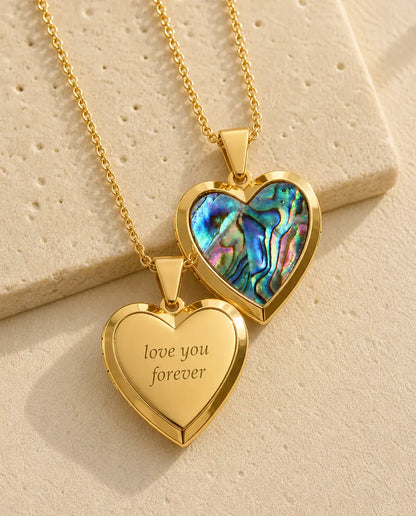 Back of the gold heart locket engraved with love you forever, abalone shell front behind