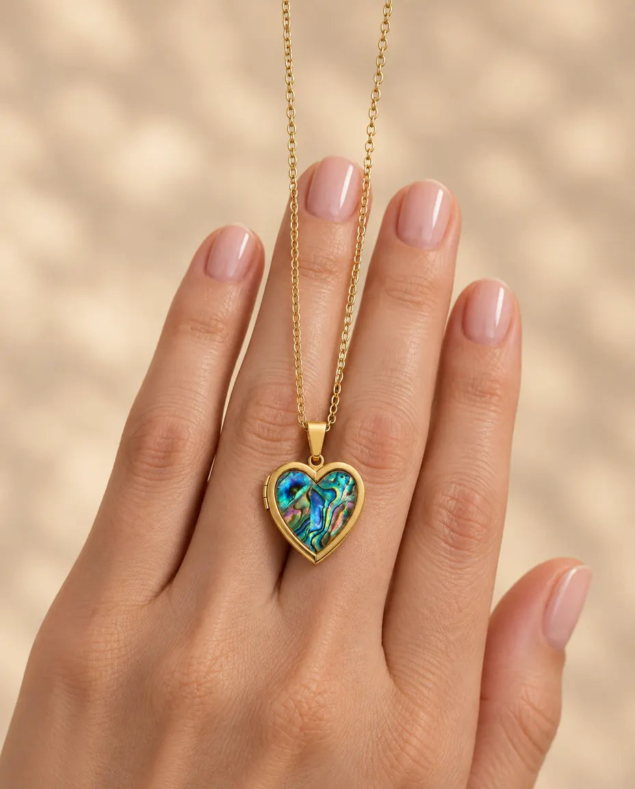 Personalized Abalone Shell Heart Locket Necklace That Holds 2 Photos held in hand