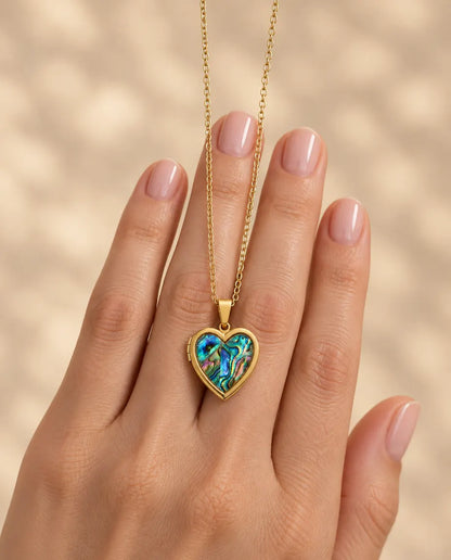 Personalized Abalone Shell Heart Locket Necklace That Holds 2 Photos held in hand