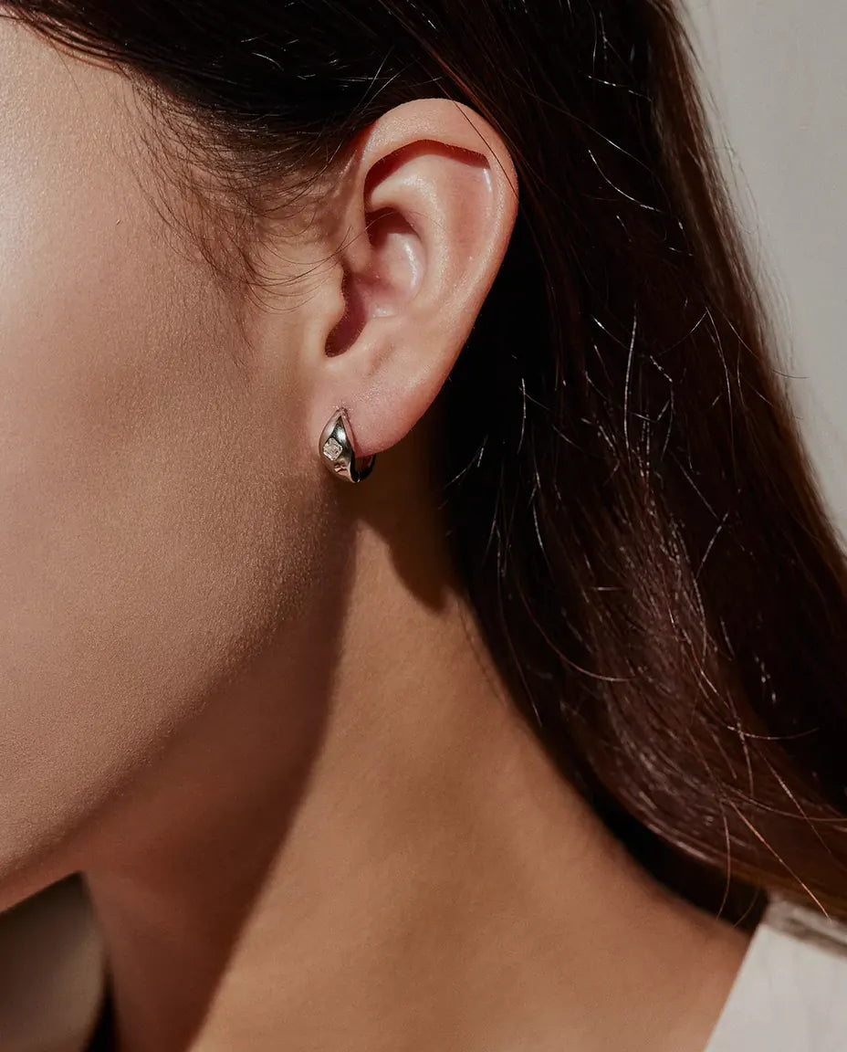Asscher Cut Moissanite Huggie Hoop Earrings in 925 Sterling Silver - worn on a model’s ear, side profile