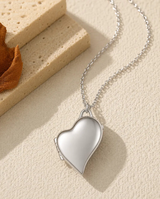 Personalized asymmetric heart photo locket necklace holding two pictures, silver and gold