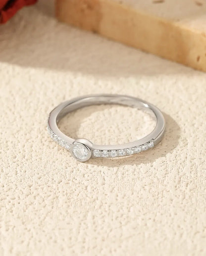 Bezel-set moissanite solitaire ring in 925 sterling silver with pave shoulders