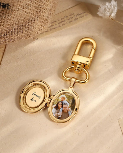 Gold oval locket keychain on vintage paper with dried flowers