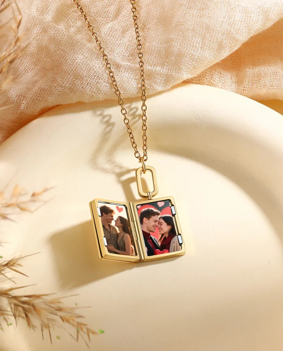 Book locket open showing two portrait photos inside