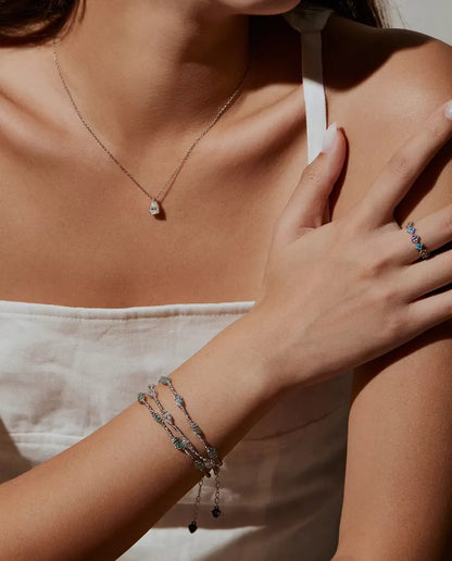 Caged Zircon Bracelet in 925 Sterling Silver - worn on the wrist with a necklace and a ring