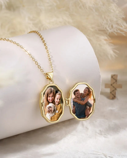 Gold cross photo locket necklace open showing two family photos inside