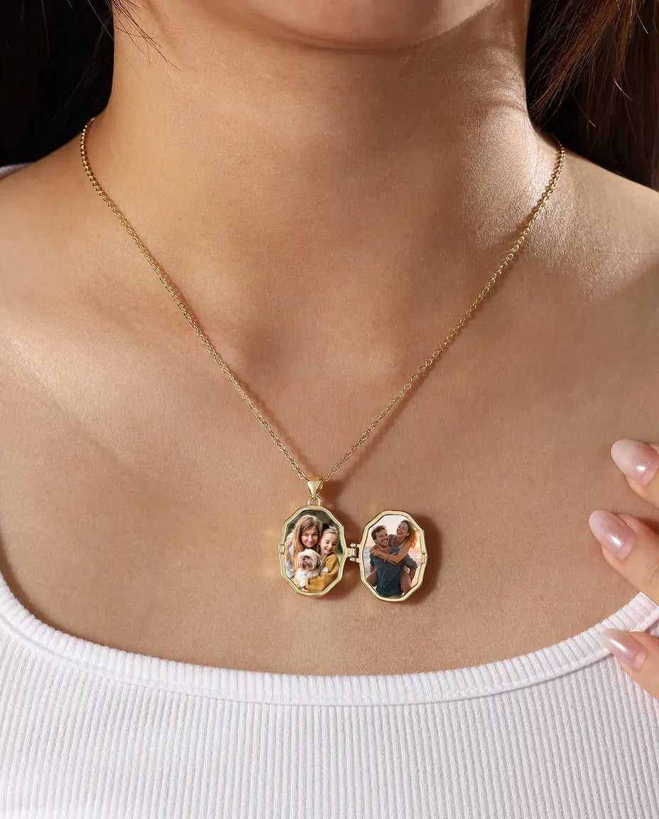 Model showing opened cross photo locket necklace with two pictures