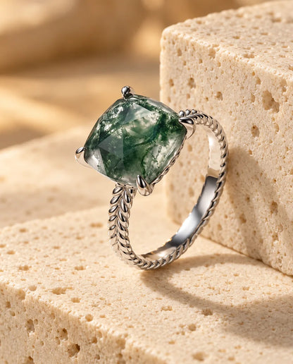 Statement Cushion Cut Moss Agate Ring - displayed on a travertine block