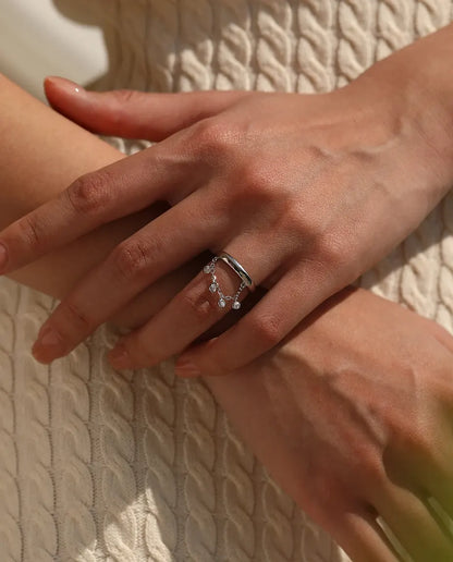 Sterling silver charm ring with draped chain and bezel set cubic zirconia drops