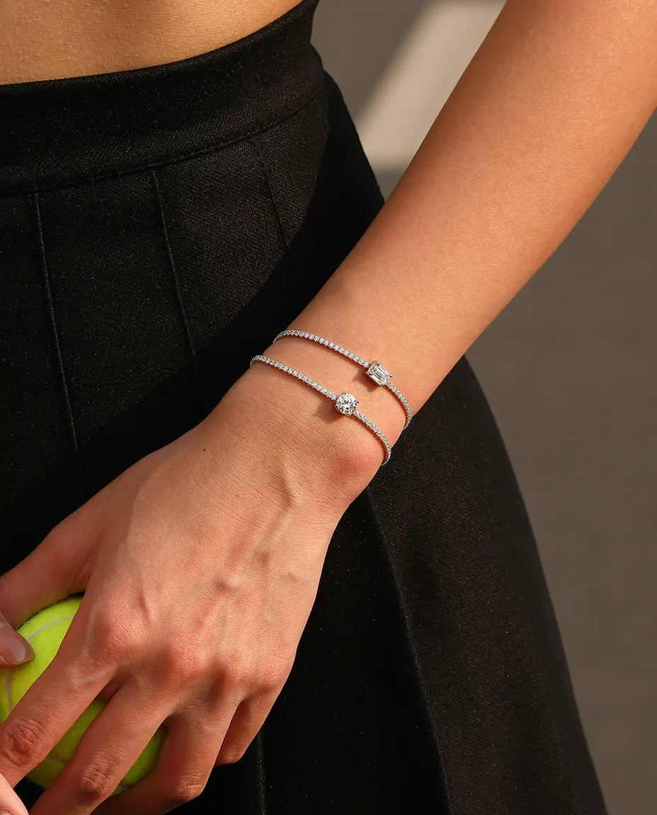 Tennis bracelet with a 1ct D color emerald cut moissanite center stone and cubic zirconia side stones, 925 sterling silver