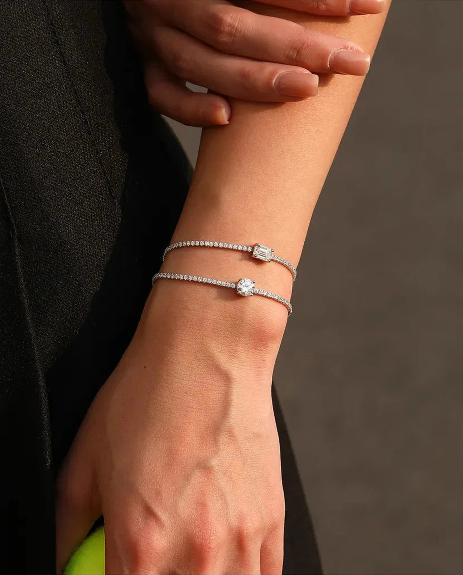 Tennis bracelet with a 1ct D color emerald cut moissanite center stone and cubic zirconia side stones, 925 sterling silver