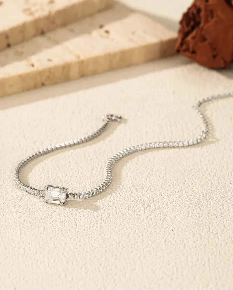 Tennis bracelet with a 1ct D color emerald cut moissanite center stone and cubic zirconia side stones, 925 sterling silver