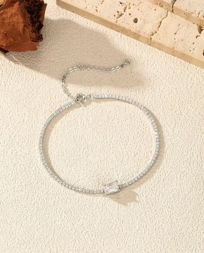 emerald cut moissanite tennis bracelet in 925 sterling silver on a wrist