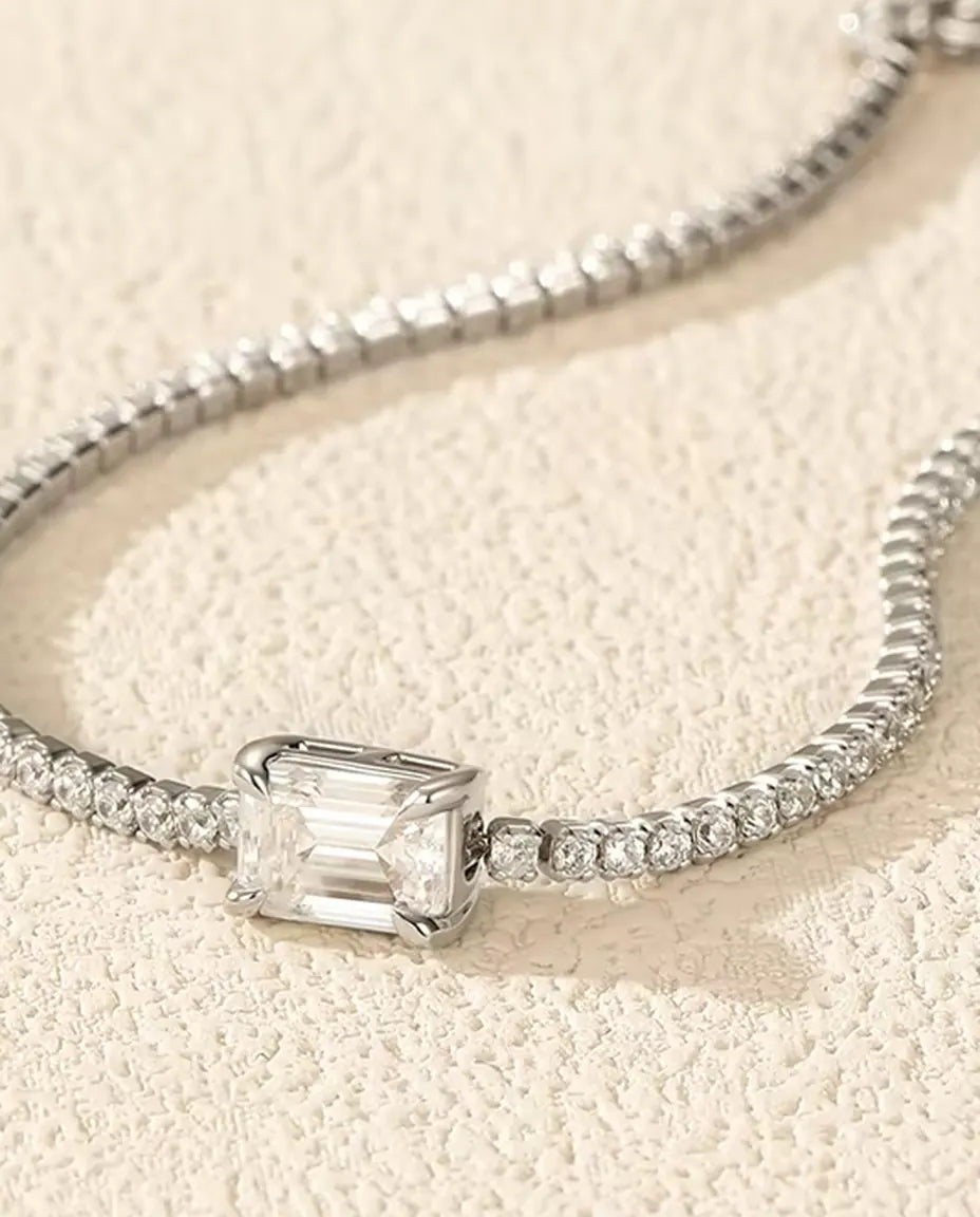 emerald cut moissanite tennis bracelet in 925 sterling silver on a wrist