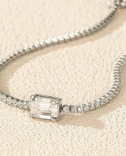 emerald cut moissanite tennis bracelet in 925 sterling silver on a wrist