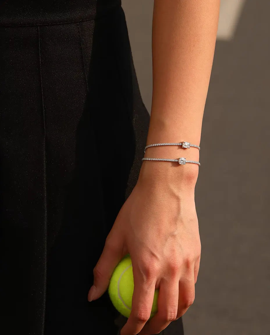 emerald cut moissanite tennis bracelet in 925 sterling silver on a wrist