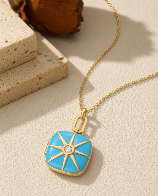 Turquoise enamel photo locket necklace with a gold starburst and crystal center