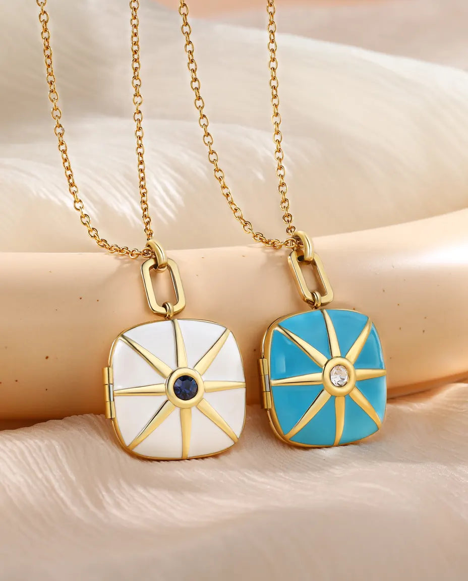 Turquoise and white enamel starburst lockets side by side