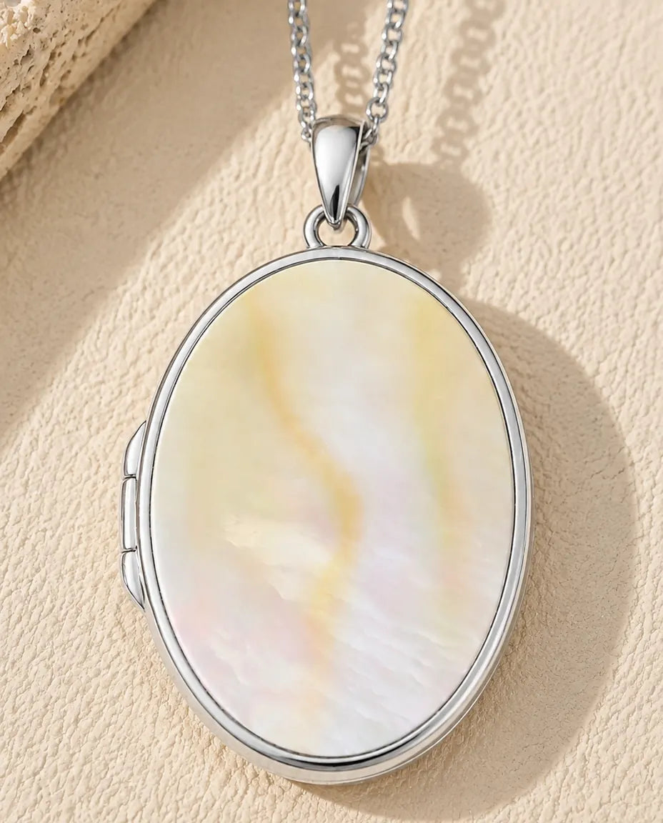Mother of pearl back panel of the engravable oval photo locket