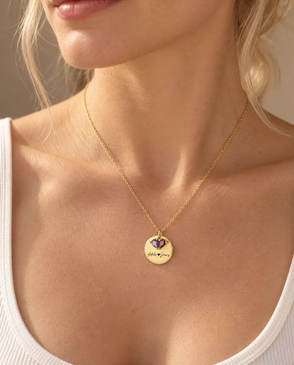 Blonde woman wearing the personalized gold disc birthstone necklace