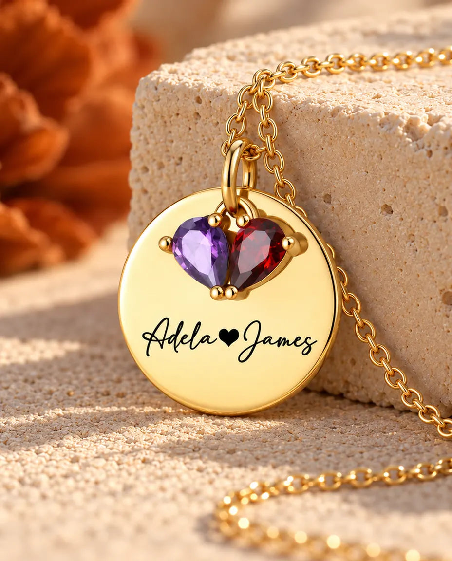 Gold disc name necklace photographed from a low angle
