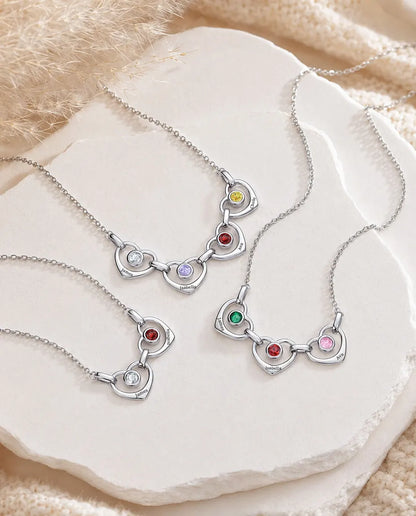 Three family birthstone necklaces with different numbers of hearts