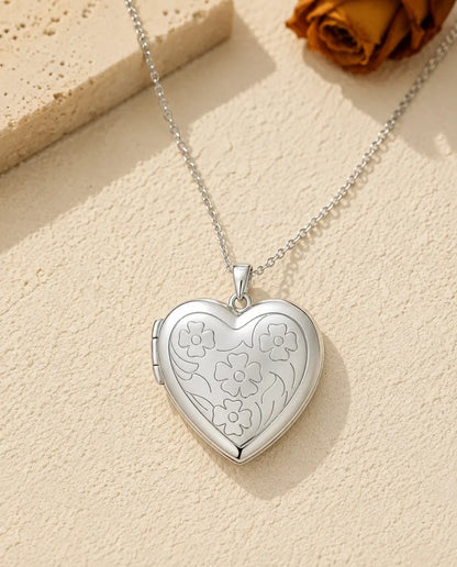 Floral carved heart photo locket necklace in silver, front view