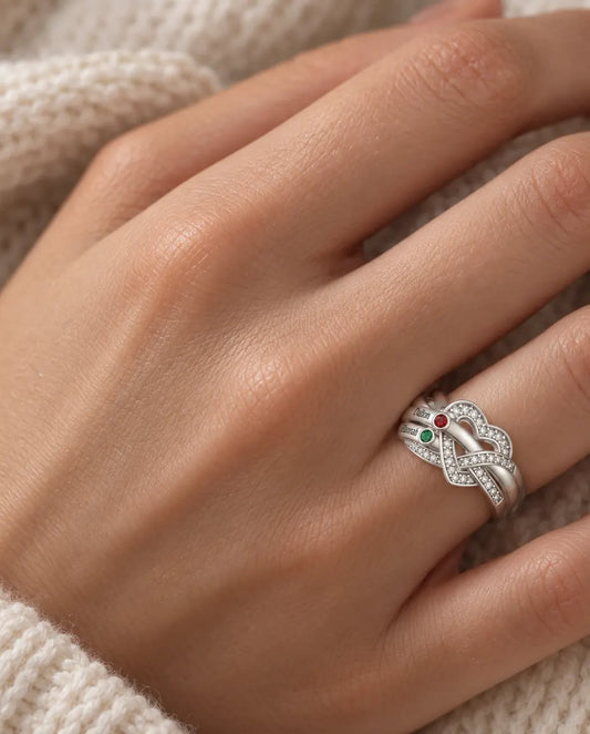 woman wearing personalized heart knot birthstone ring with 2 engraved names on her ring finger