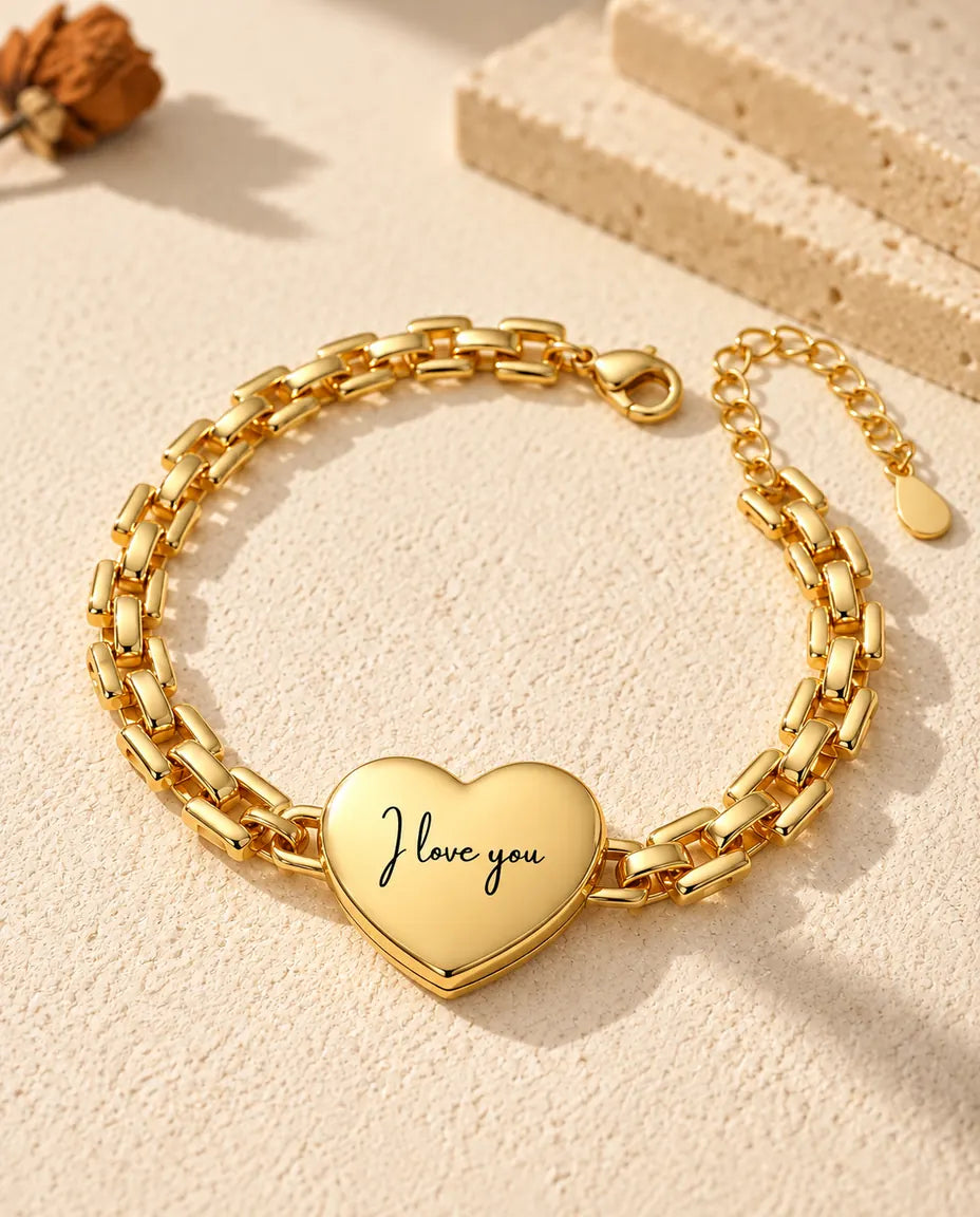 Back of the gold-tone heart locket bracelet engraved “I love you” in script
