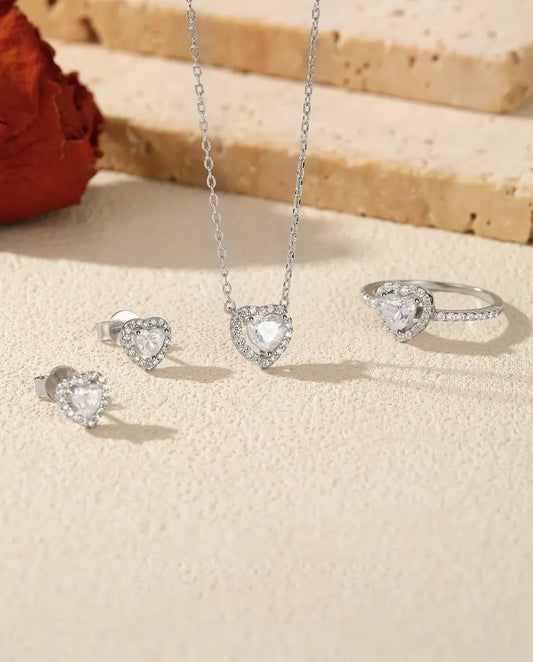 Heart Moissanite Jewelry Set in 925 Sterling Silver - the full set on a cream stone surface