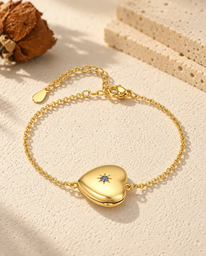 Personalized gold-tone heart photo locket bracelet with a birthstone set in a star on the front