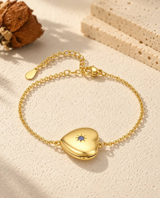 Personalized gold-tone heart photo locket bracelet with a birthstone set in a star on the front