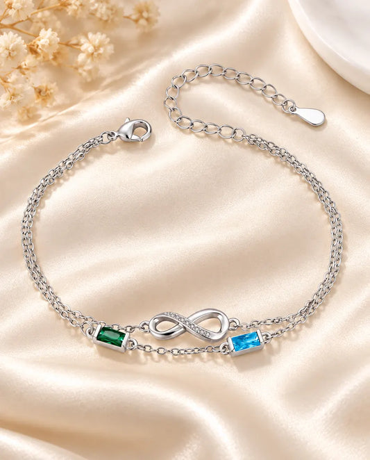 Personalized infinity birthstone bracelet with two baguette birthstones on a double silver chain