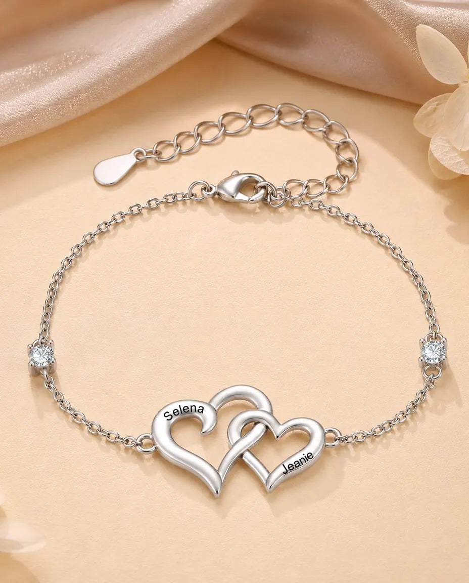 Interlocking hearts bracelet with two engraved names, silver tone