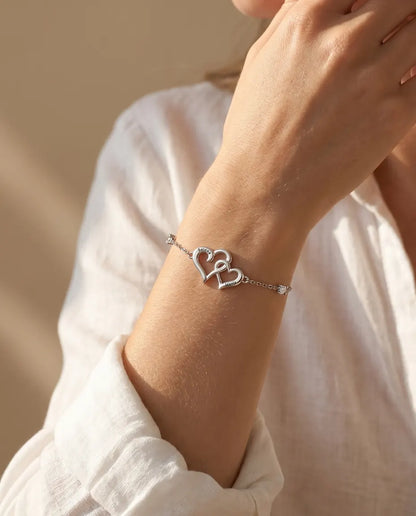 Double heart name bracelet worn on the wrist