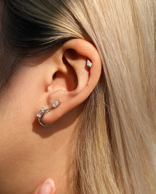 Kite Cut Moissanite Stud Earrings in 925 Sterling Silver - worn in the ear, close-up