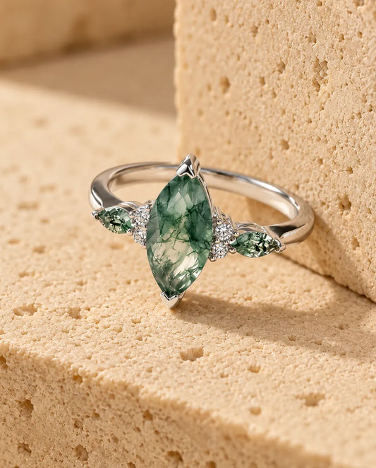 Marquise Moss Agate Ring - displayed on a travertine block