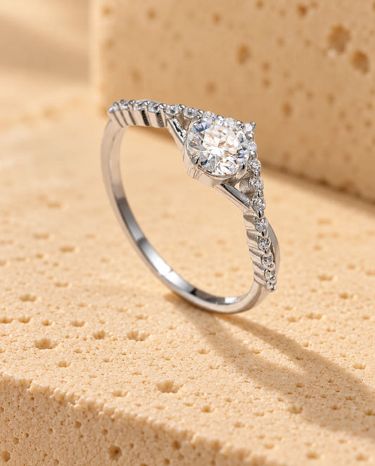 0.50Ct Moissanite Engagement Ring - displayed on a travertine block
