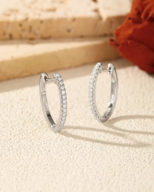 Moissanite Hoop Earrings in 925 Sterling Silver - pair standing side by side on a cream textured surface