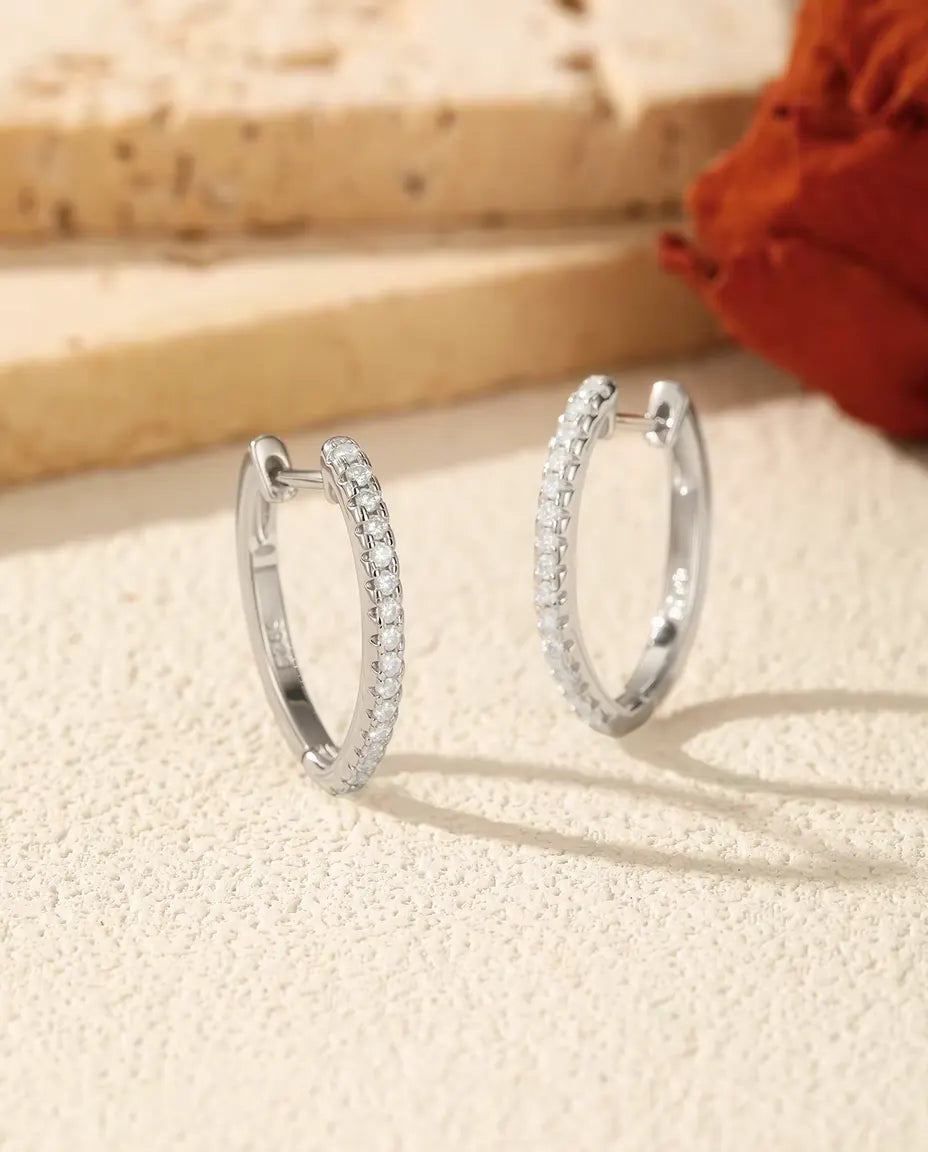 Moissanite Hoop Earrings in 925 Sterling Silver - pair standing side by side on a cream textured surface