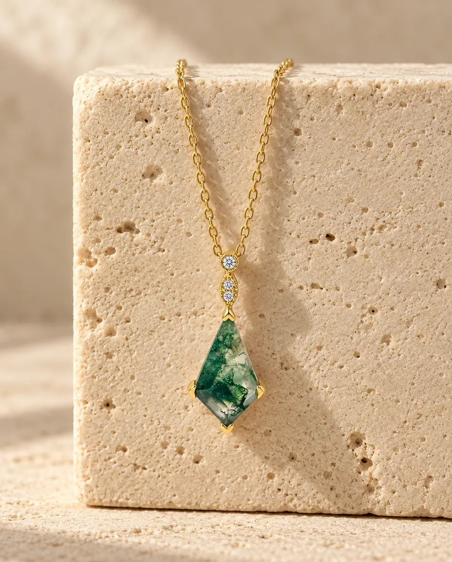 Moss Agate Necklace - displayed on a travertine block