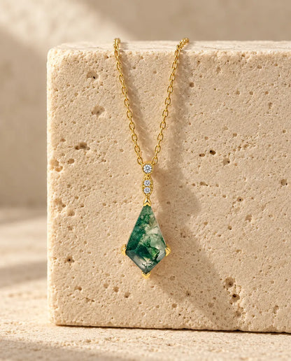Moss Agate Necklace - displayed on a travertine block