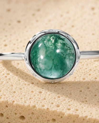 Moss agate round cabochon adjustable ring in sterling silver with sunburst bezel and thin dainty band