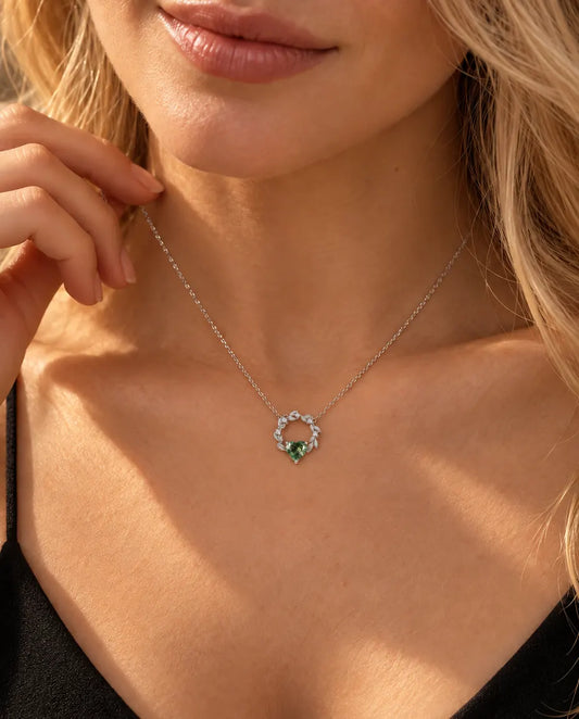 Moss Agate Heart Necklace in 925 Sterling Silver - worn on a model with her hand at her neck