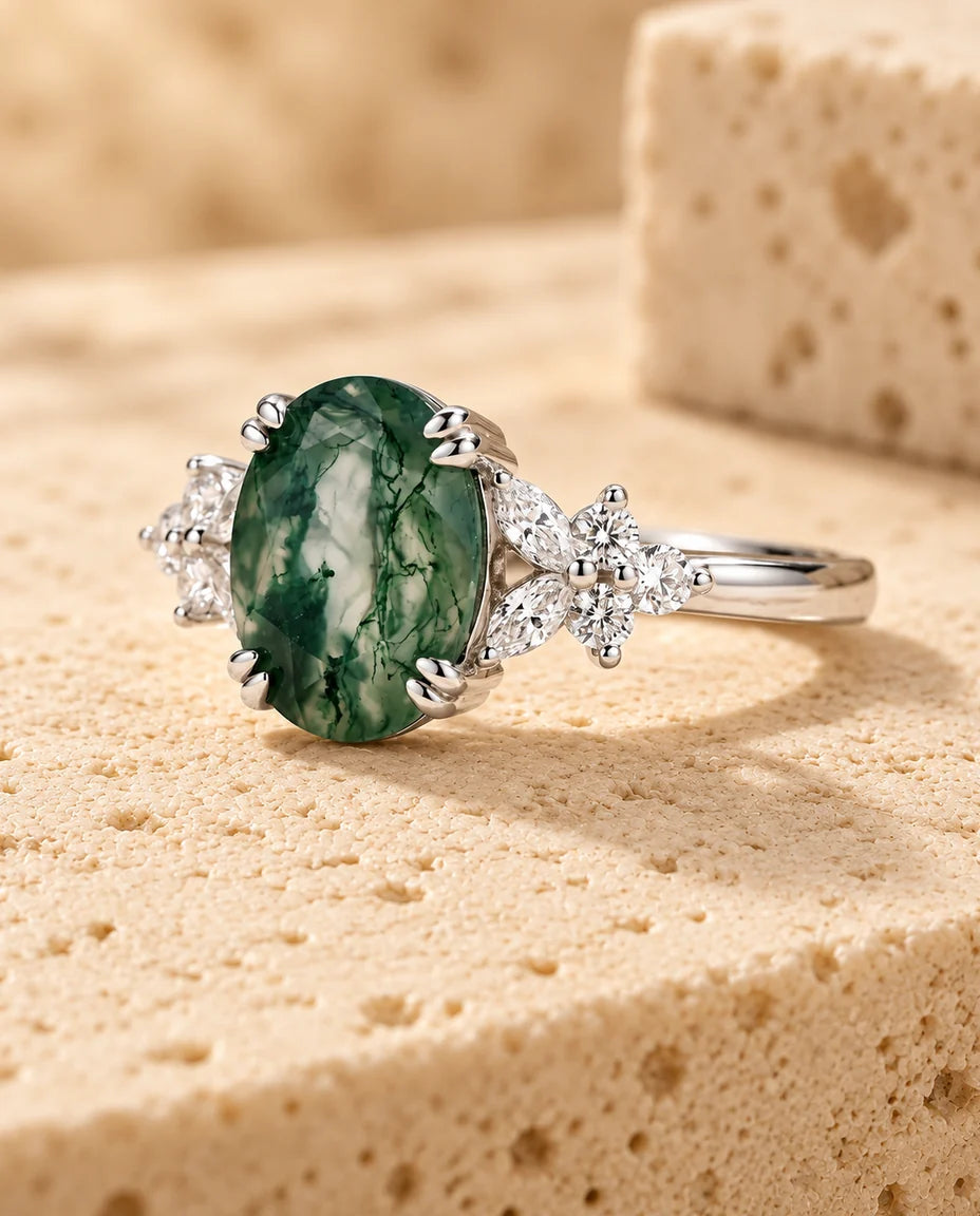 Oval Moss Agate Ring - displayed on a travertine block